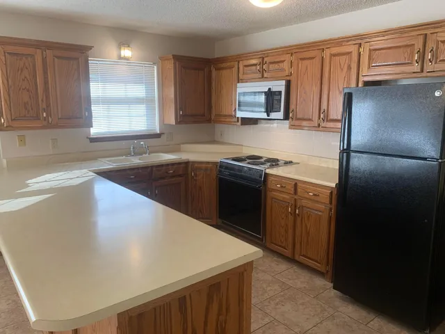 a kitchen with a sink a stove and refrigerator
