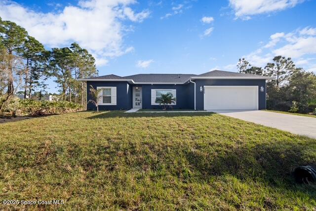 a front view of a house with a garden and trees