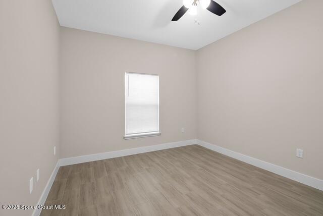 Undisclosed Address Palm Bay, FL 32909 - Photo 13 of 21 an empty room with wooden floor chandelier fan and windows