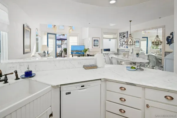 a kitchen with kitchen island white cabinets and white appliances