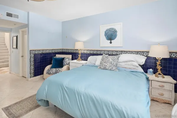 a bedroom with a bed and a lamp