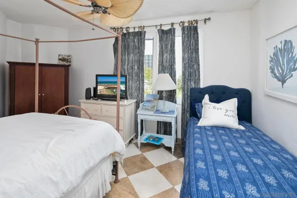 a bed room with a bed and a television