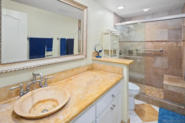a bathroom with a granite countertop sink and a mirror