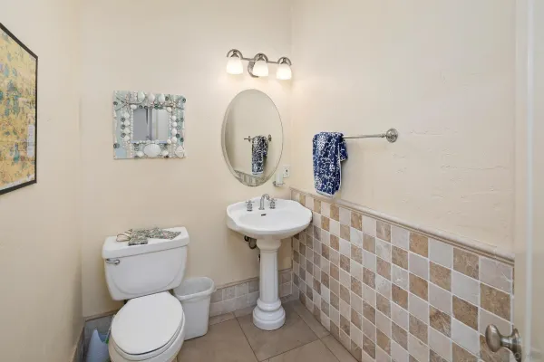 a bathroom with a toilet sink and mirror