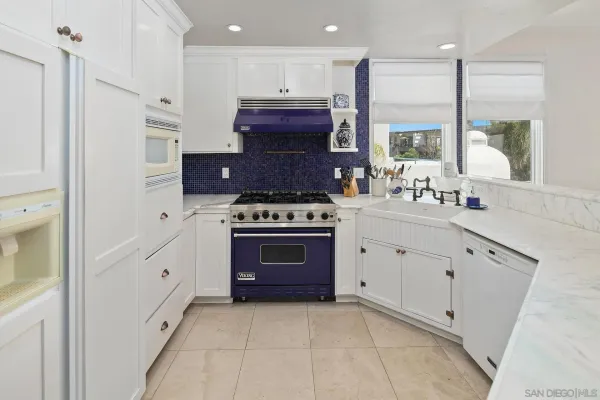 a kitchen with stainless steel appliances a stove a sink and a refrigerator