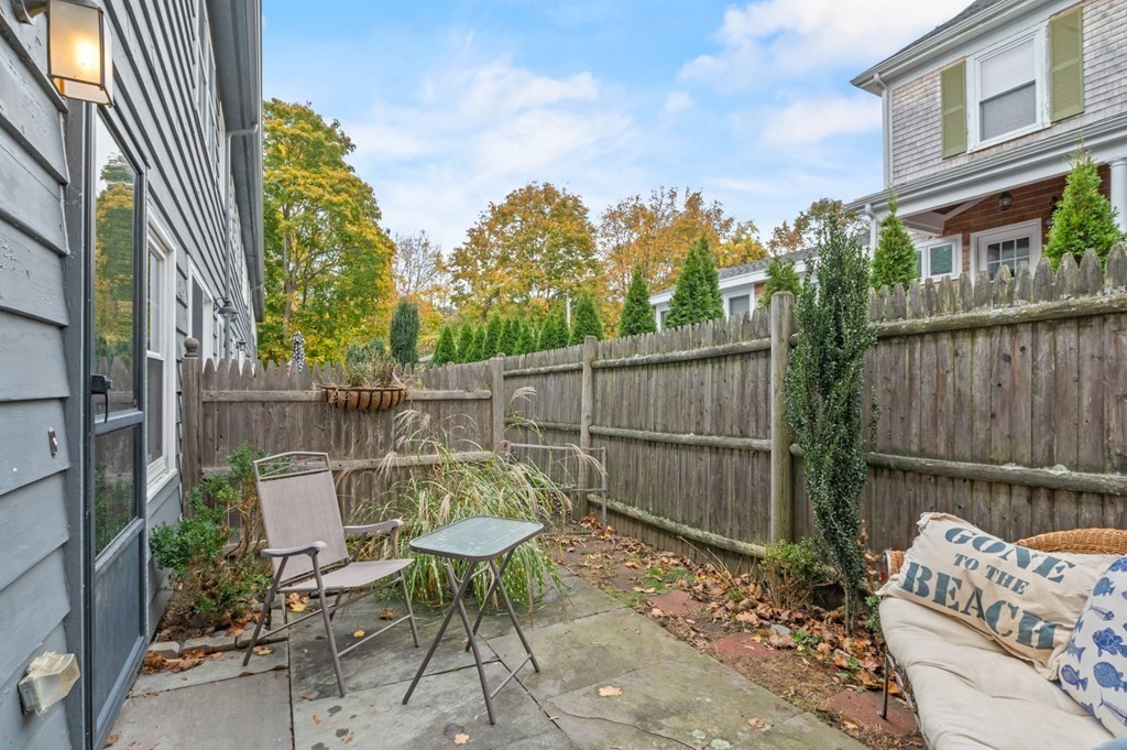 27 Norwood Avenue, Unit 2 Manchester, MA 01944 - Photo 12 of 17 a view of a chairs and table in the back yard of the house