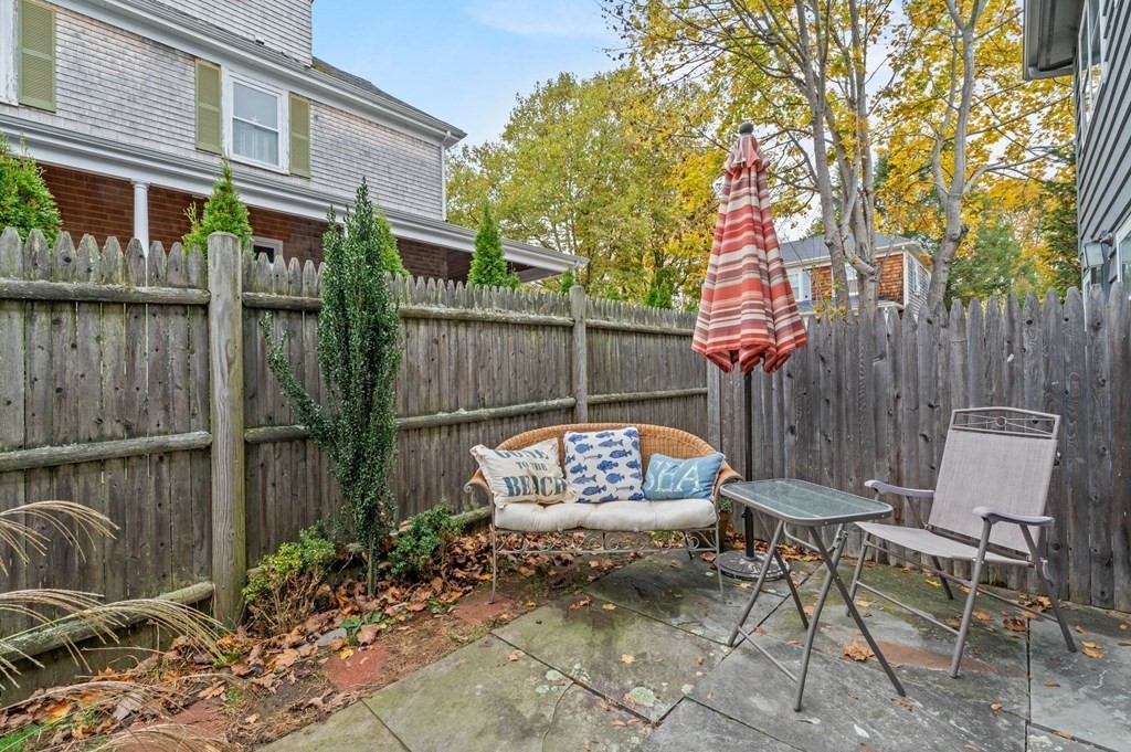 27 Norwood Avenue, Unit 2 Manchester, MA 01944 - Photo 14 of 17 a view of a chairs and table in backyard of the house