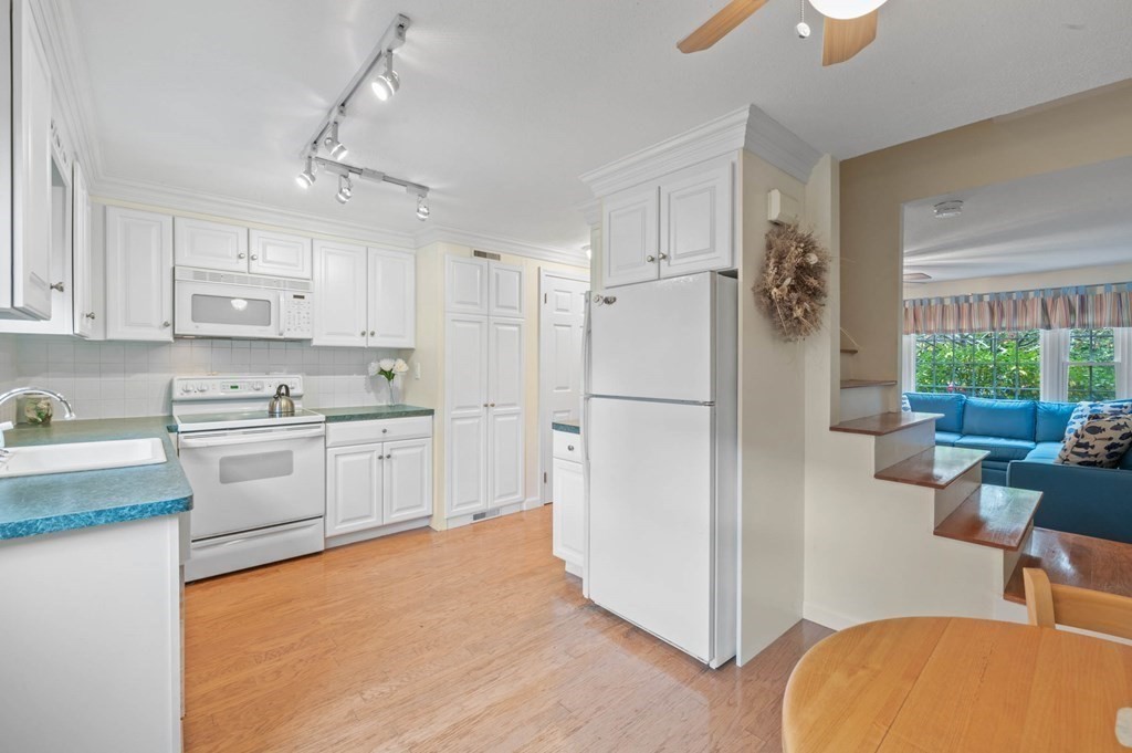 27 Norwood Avenue, Unit 2 Manchester, MA 01944 - Photo 8 of 17 a kitchen with white cabinets and white appliances