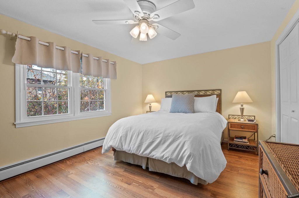 27 Norwood Avenue, Unit 2 Manchester, MA 01944 - Photo 9 of 17 a bedroom with a bed and a chandelier