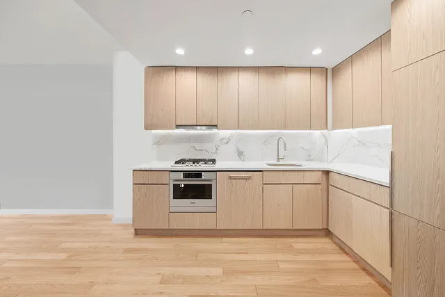 a kitchen with a sink table and chairs