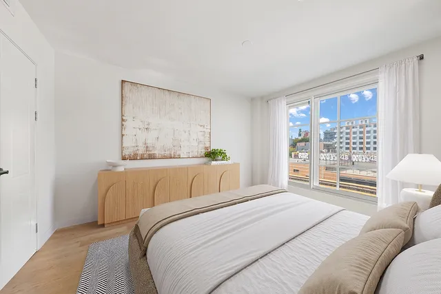 a bedroom with a bed and a window with outer view