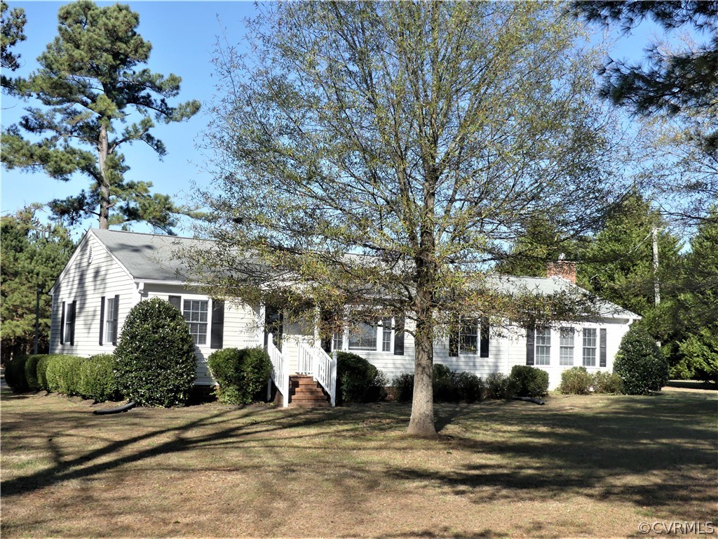 1325 Courthouse Road Chase City, VA 23924 - Photo 1 of 49 a front view of a house with a garden