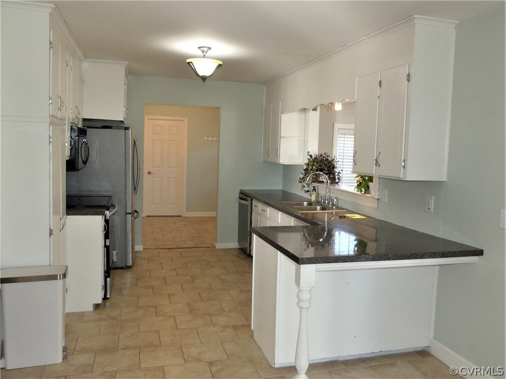 1325 Courthouse Road Chase City, VA 23924 - Photo 17 of 49 a kitchen with stainless steel appliances granite countertop a sink a stove and refrigerator