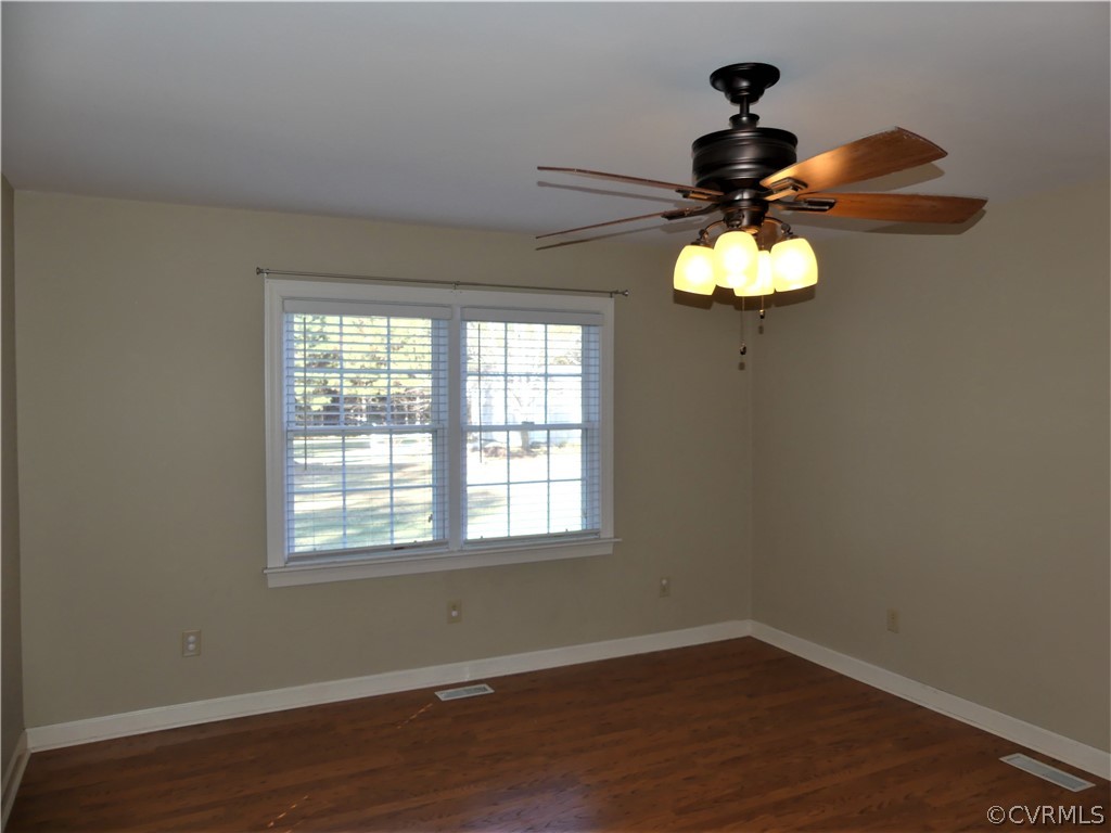 1325 Courthouse Road Chase City, VA 23924 - Photo 23 of 49 an empty room with wooden floor and windows