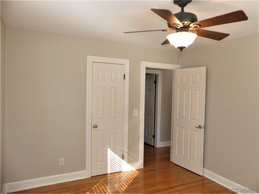 1325 Courthouse Road Chase City, VA 23924 - Photo 29 of 49 wooden floor in an empty room with a chandelier fan