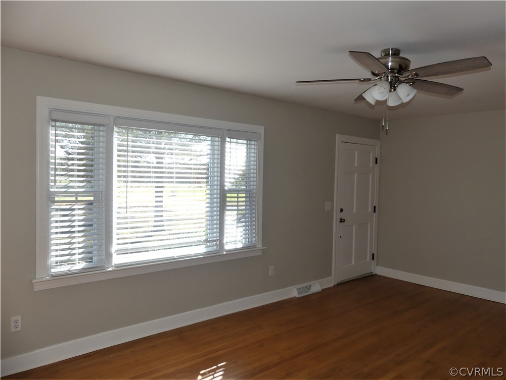1325 Courthouse Road Chase City, VA 23924 - Photo 9 of 49 a view of an empty room with wooden floor and a window