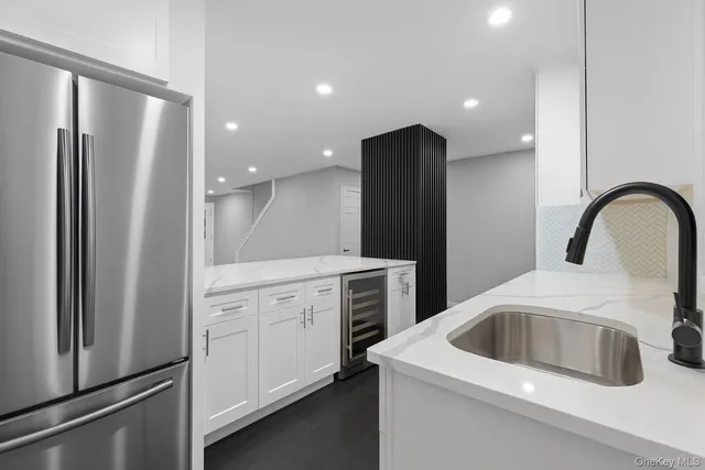 a kitchen with a sink and refrigerator