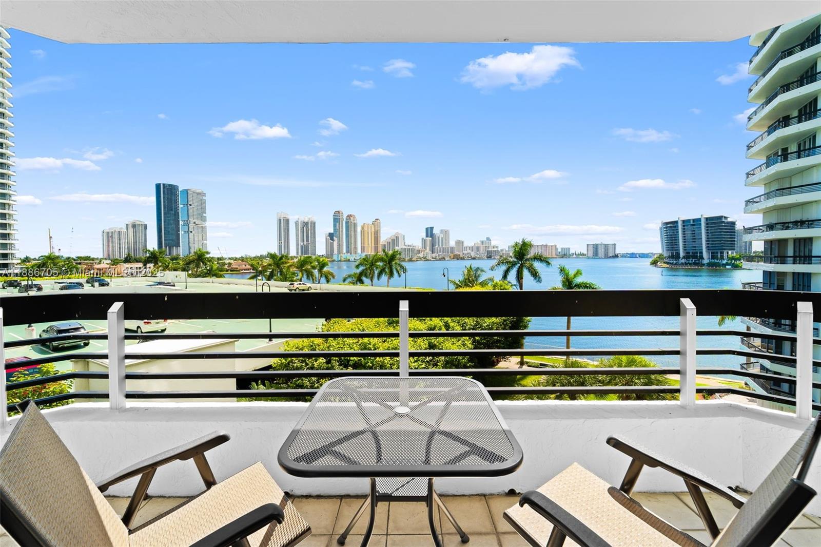 3600 Mystic Pointe Drive, Unit 614 Aventura, FL 33180 - Photo 3 of 14 a view of a chairs and table in a terrace