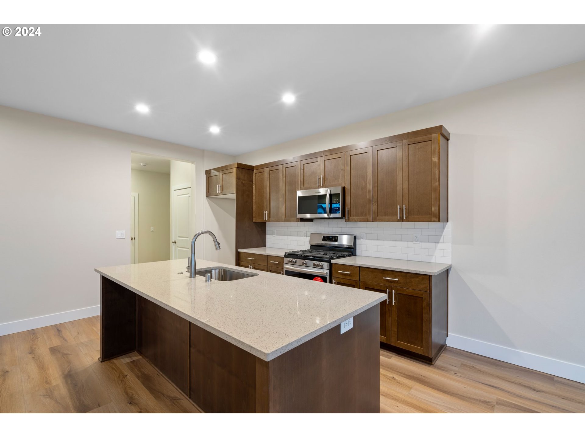 829 Northwest 175th Way Ridgefield, WA 98642 - Photo 5 of 17 a kitchen with a sink a stove a refrigerator and cabinets