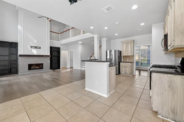 a view of a kitchen with a sink and an empty room
