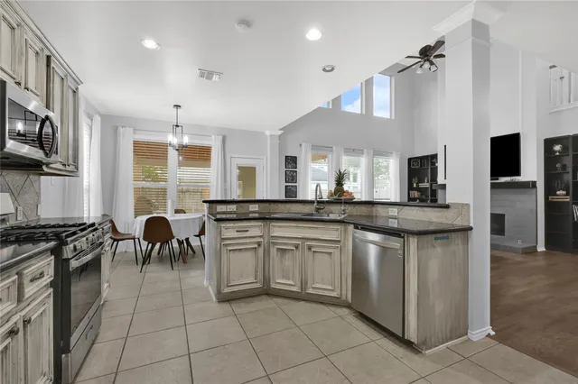 a kitchen with stainless steel appliances granite countertop a stove and a sink