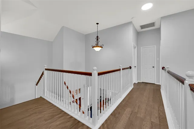 a view of a hallway with stairs