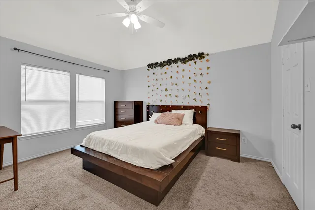 a large bed sitting in a bedroom next to a window