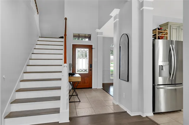 a view of staircase with white walls and railing