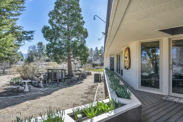 a view of a house with a yard and a wooden fence