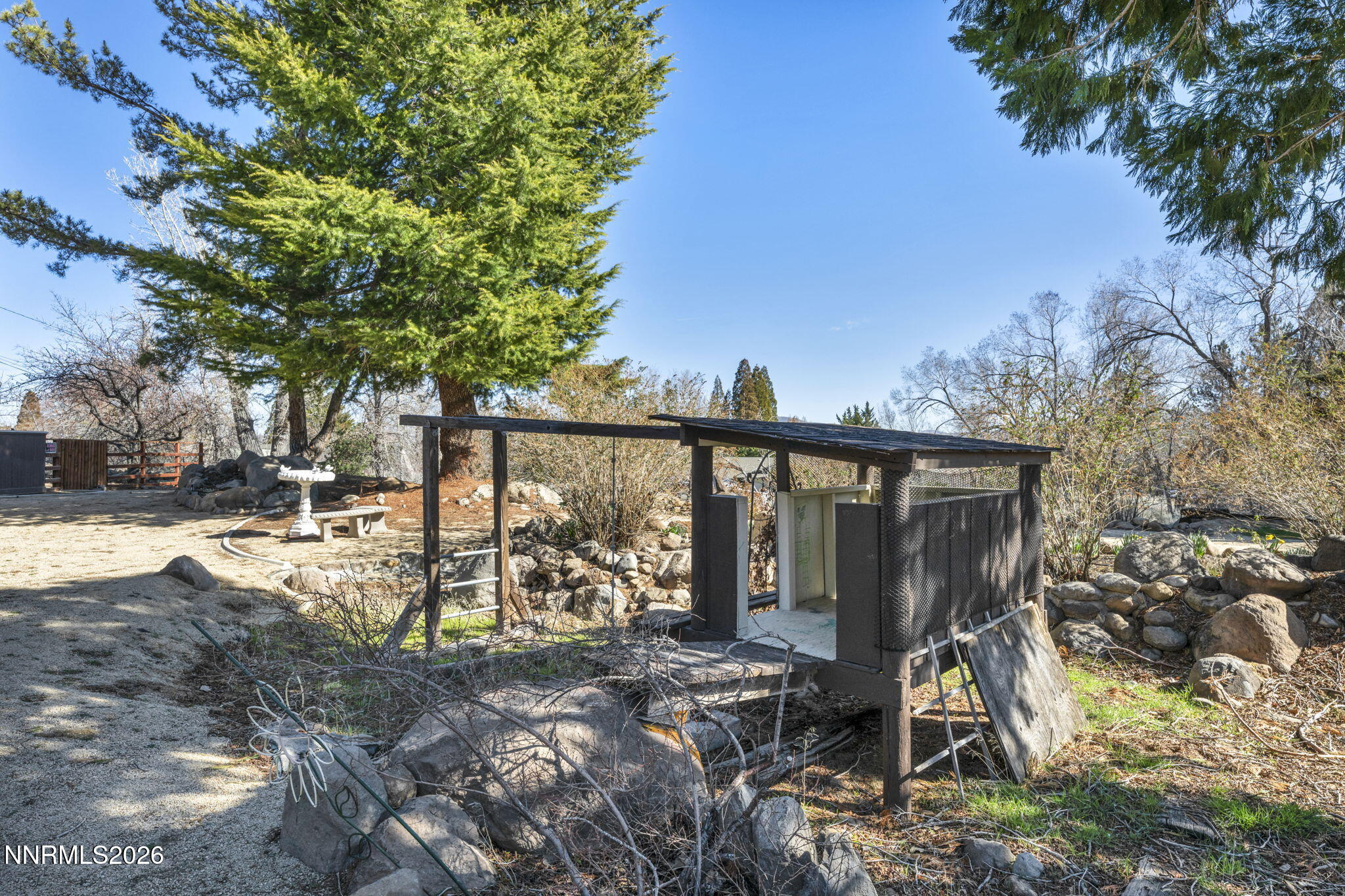13600 Stoneybrook Drive Reno, NV 89511 - Photo 48 of 120 a view of a backyard with large trees