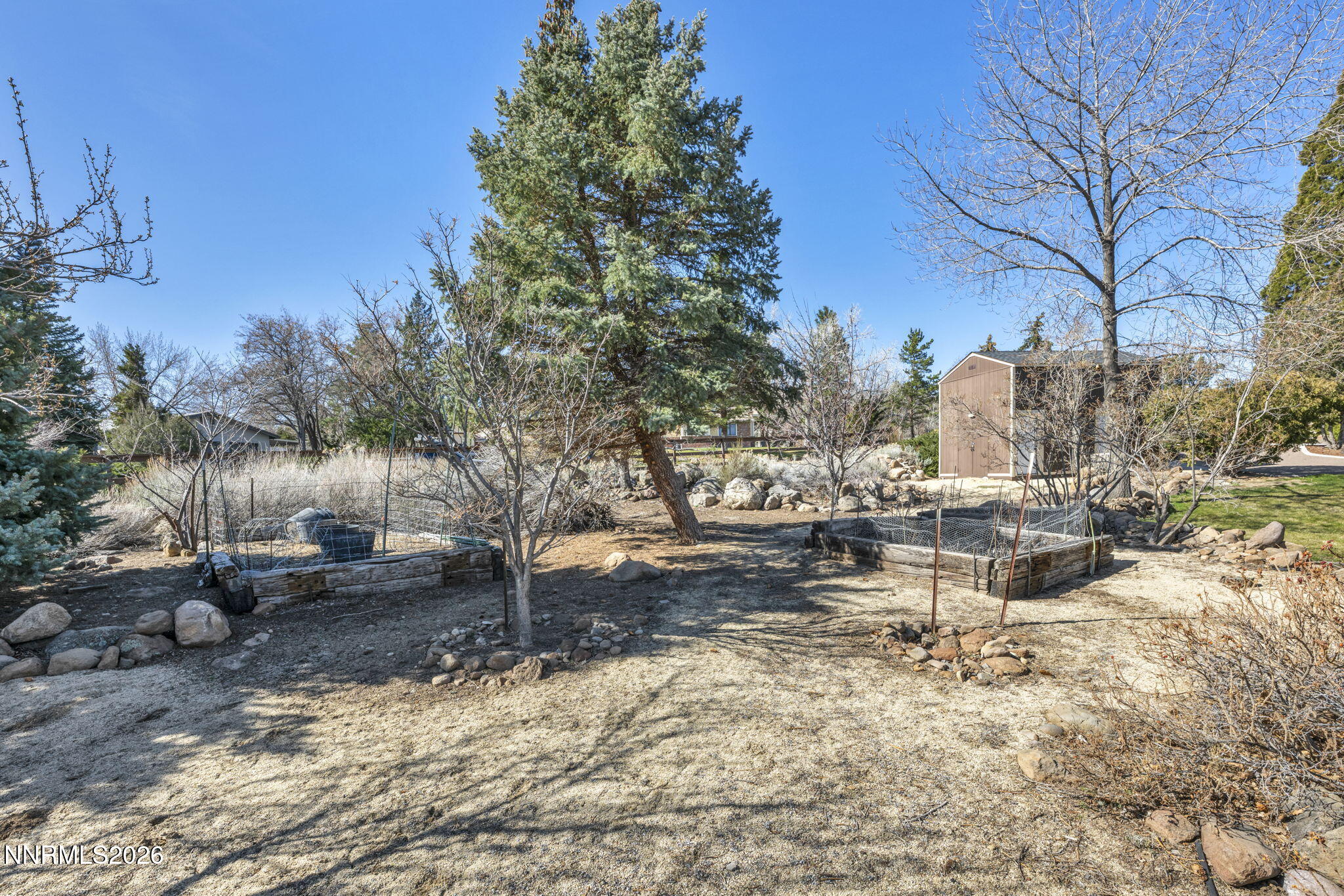 13600 Stoneybrook Drive Reno, NV 89511 - Photo 51 of 120 a view of a fire pit with large trees