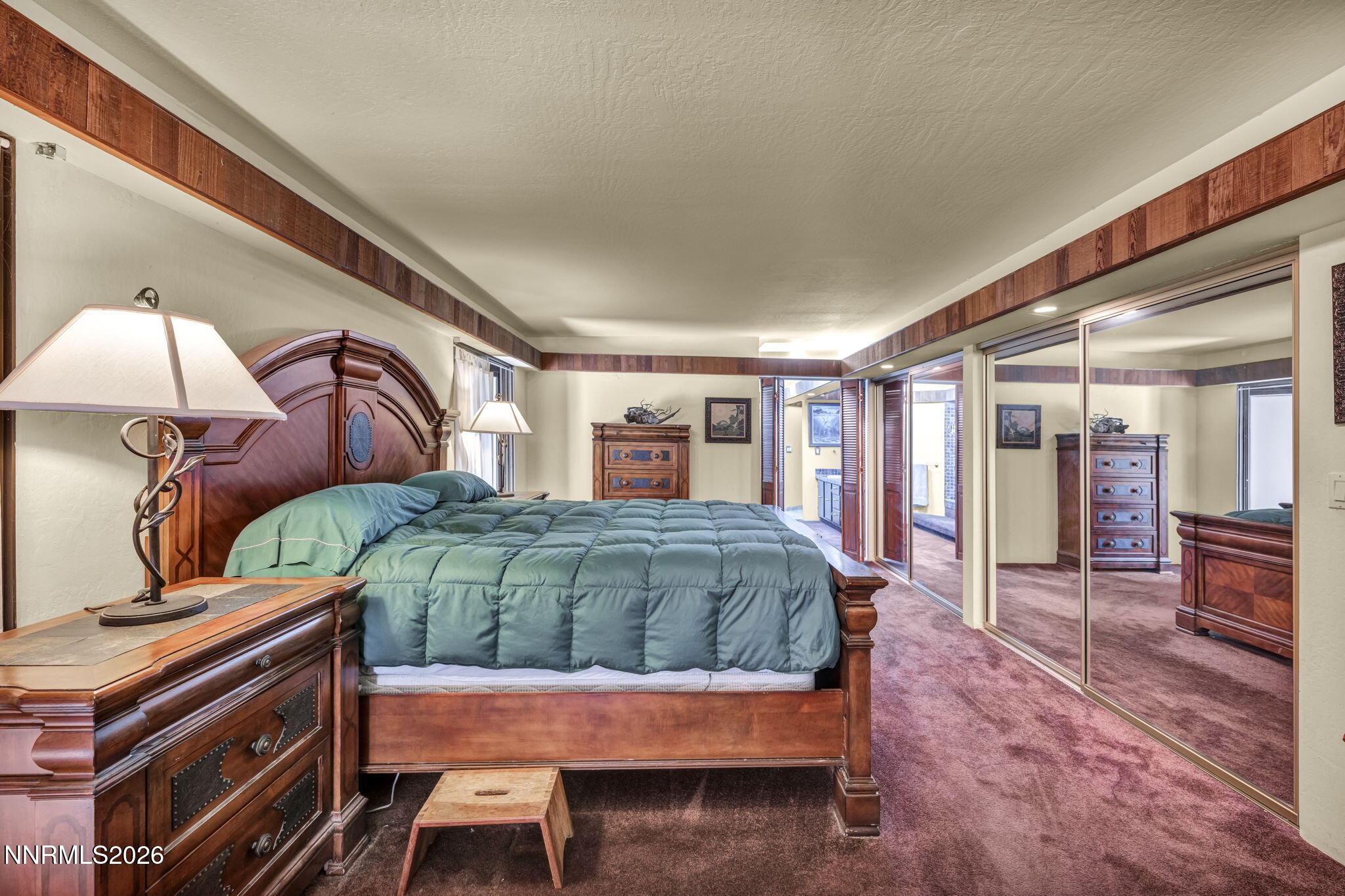 13600 Stoneybrook Drive Reno, NV 89511 - Photo 97 of 120 a bedroom with a large bed and a chandelier