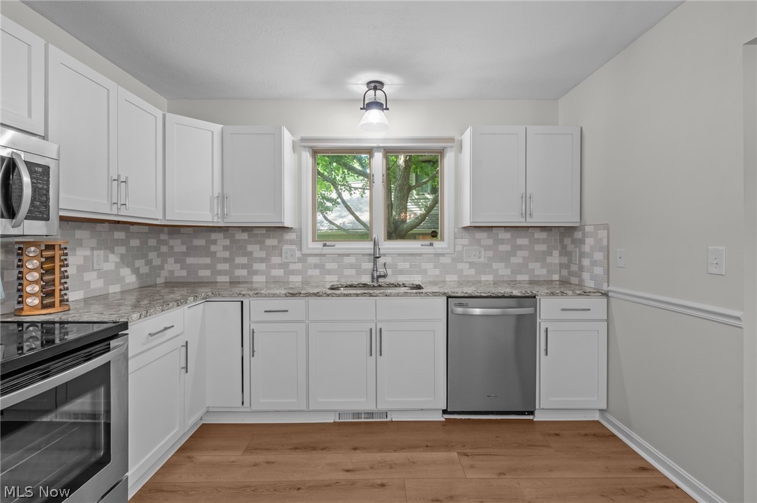 73 Lethbridge Lane Akron, OH 44321 - Photo 12 of 44 white cabinetry, stylish tile backsplash...