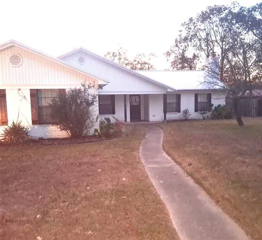 a backyard of a house with yard and outdoor seating