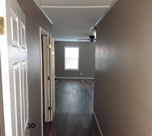 an empty room with wooden floor and a window