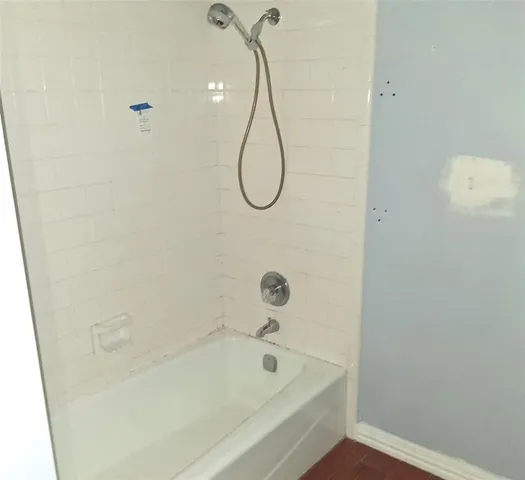 a bathroom with a bath tub and a shower