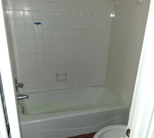 a bathroom with a shower and toilet