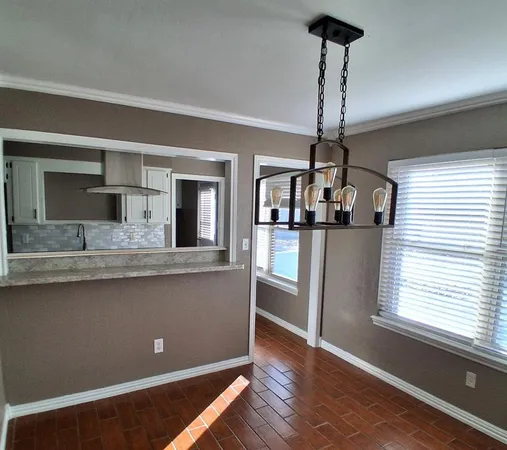a kitchen with stainless steel appliances granite countertop a sink refrigerator and window