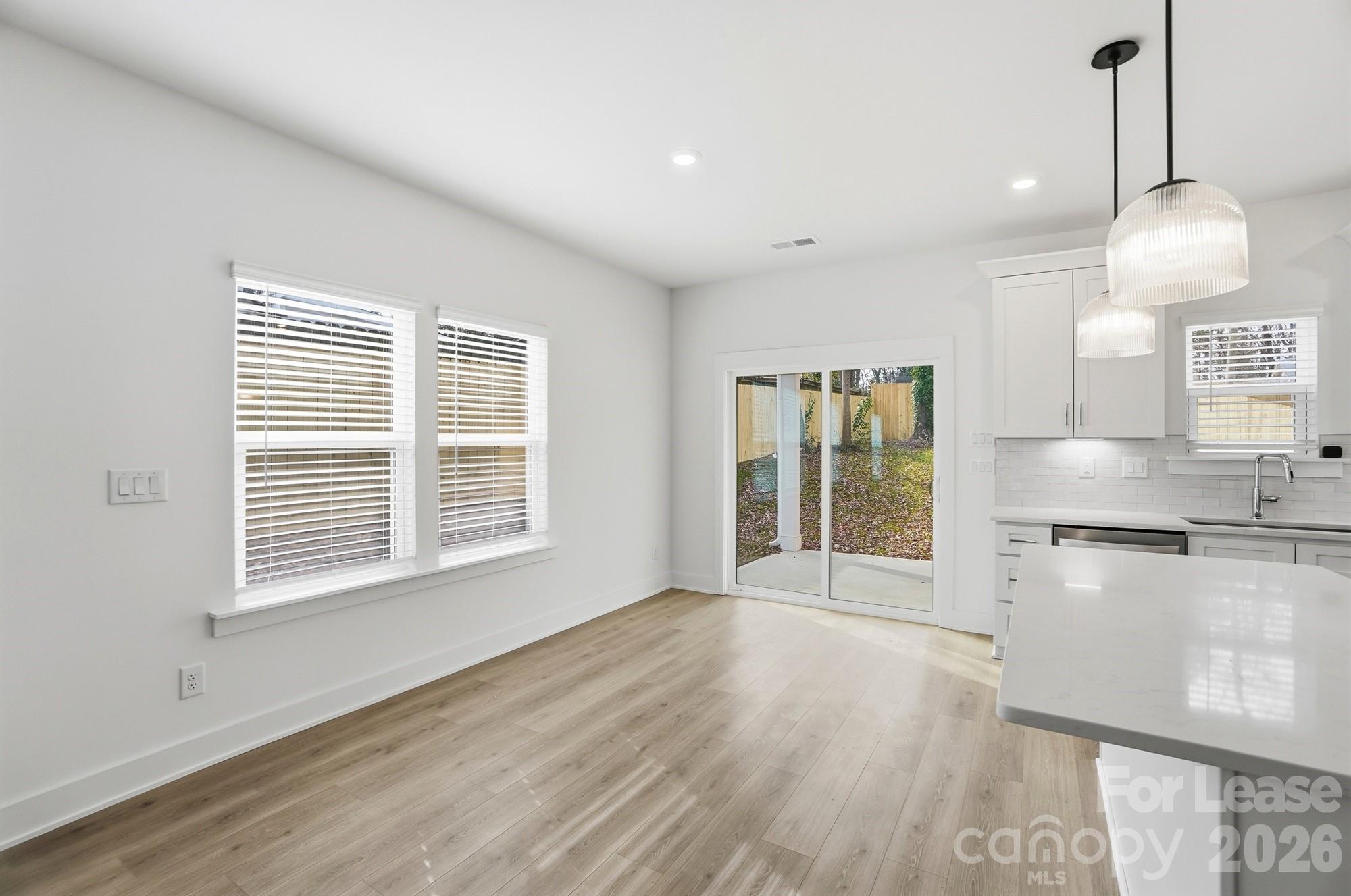 3941 Tillman Road Charlotte, NC 28208 - Photo 12 of 48 a view of a kitchen with wooden floor and a window