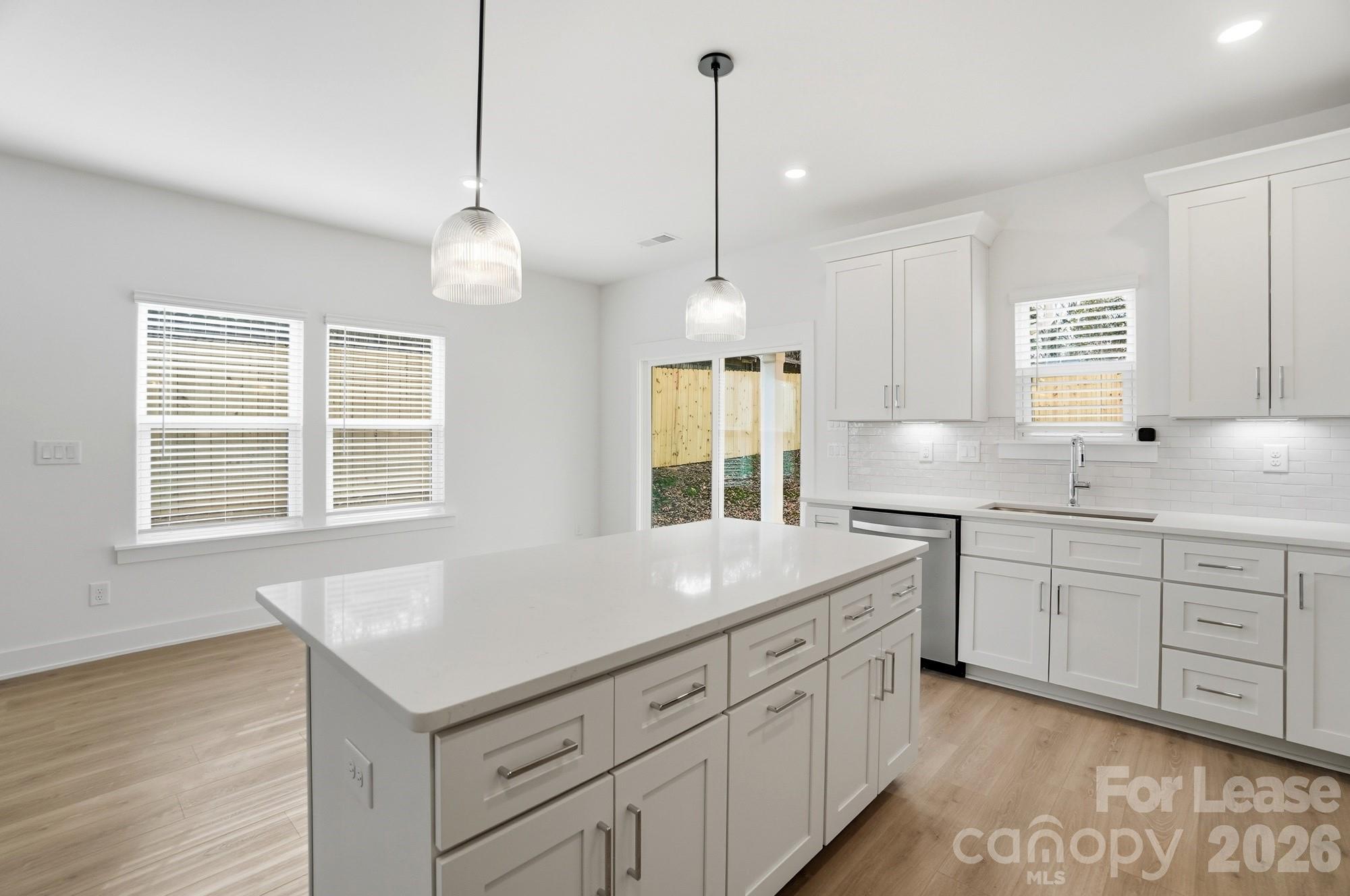 3941 Tillman Road Charlotte, NC 28208 - Photo 16 of 48 a kitchen with sink cabinets and wooden floor