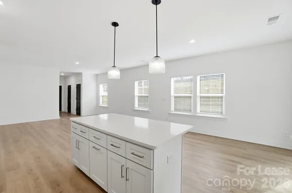 a kitchen with stainless steel appliances granite countertop a refrigerator a stove a sink and a oven