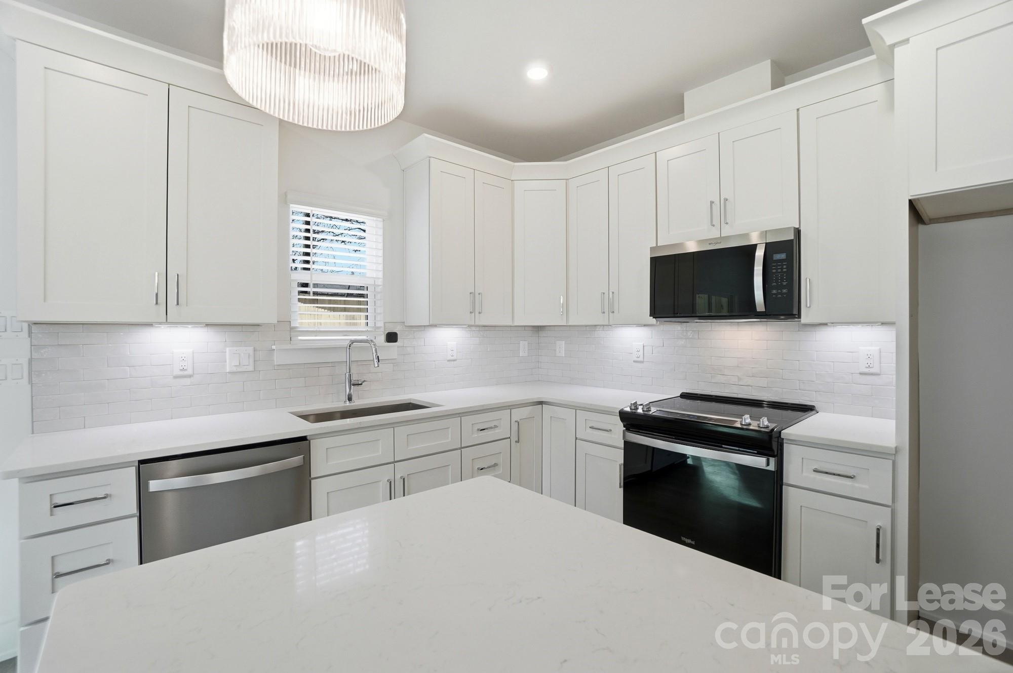 3941 Tillman Road Charlotte, NC 28208 - Photo 20 of 48 a kitchen with stainless steel appliances white cabinets and a sink