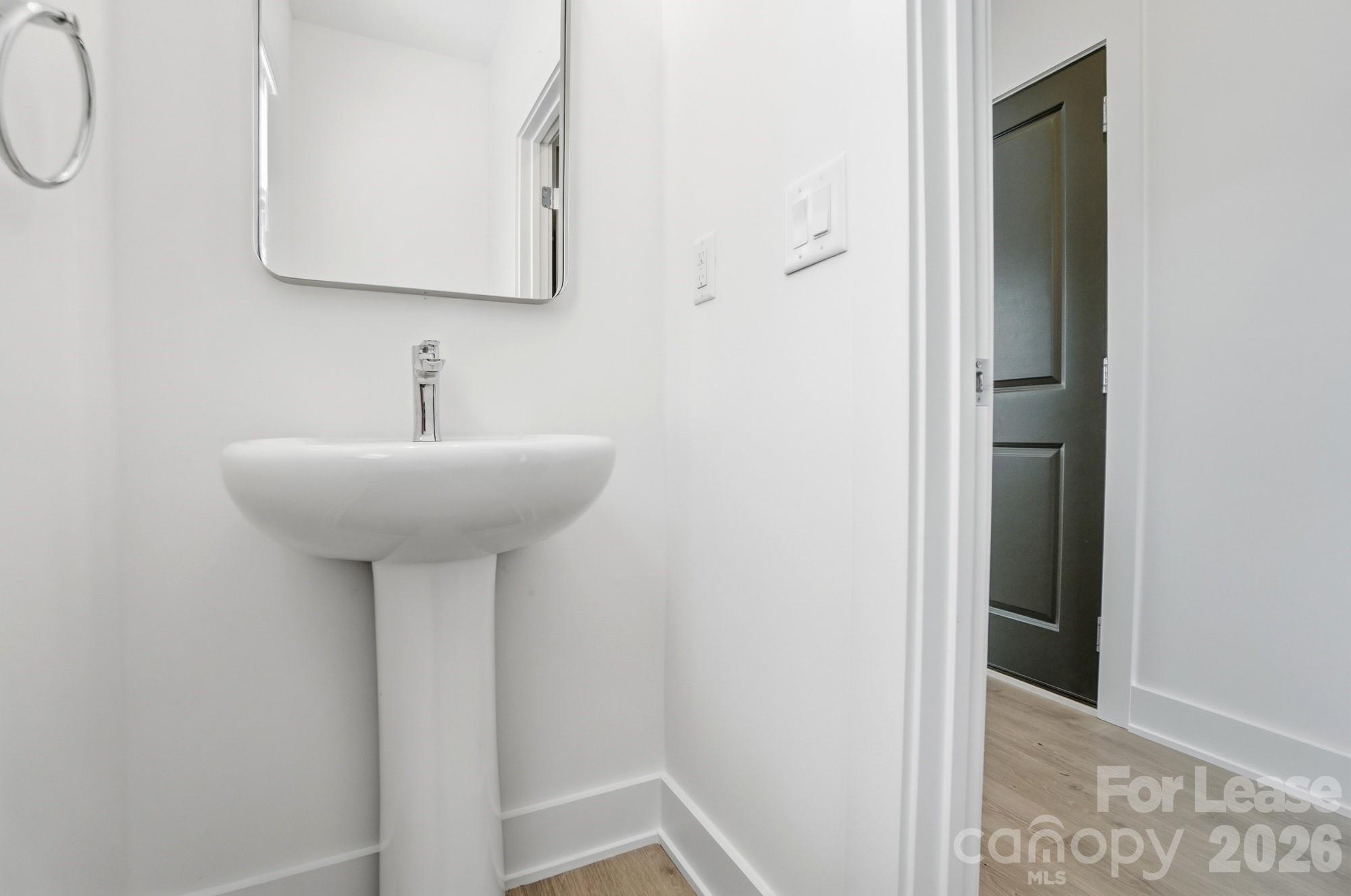 3941 Tillman Road Charlotte, NC 28208 - Photo 22 of 48 a bathroom with a sink and a mirror