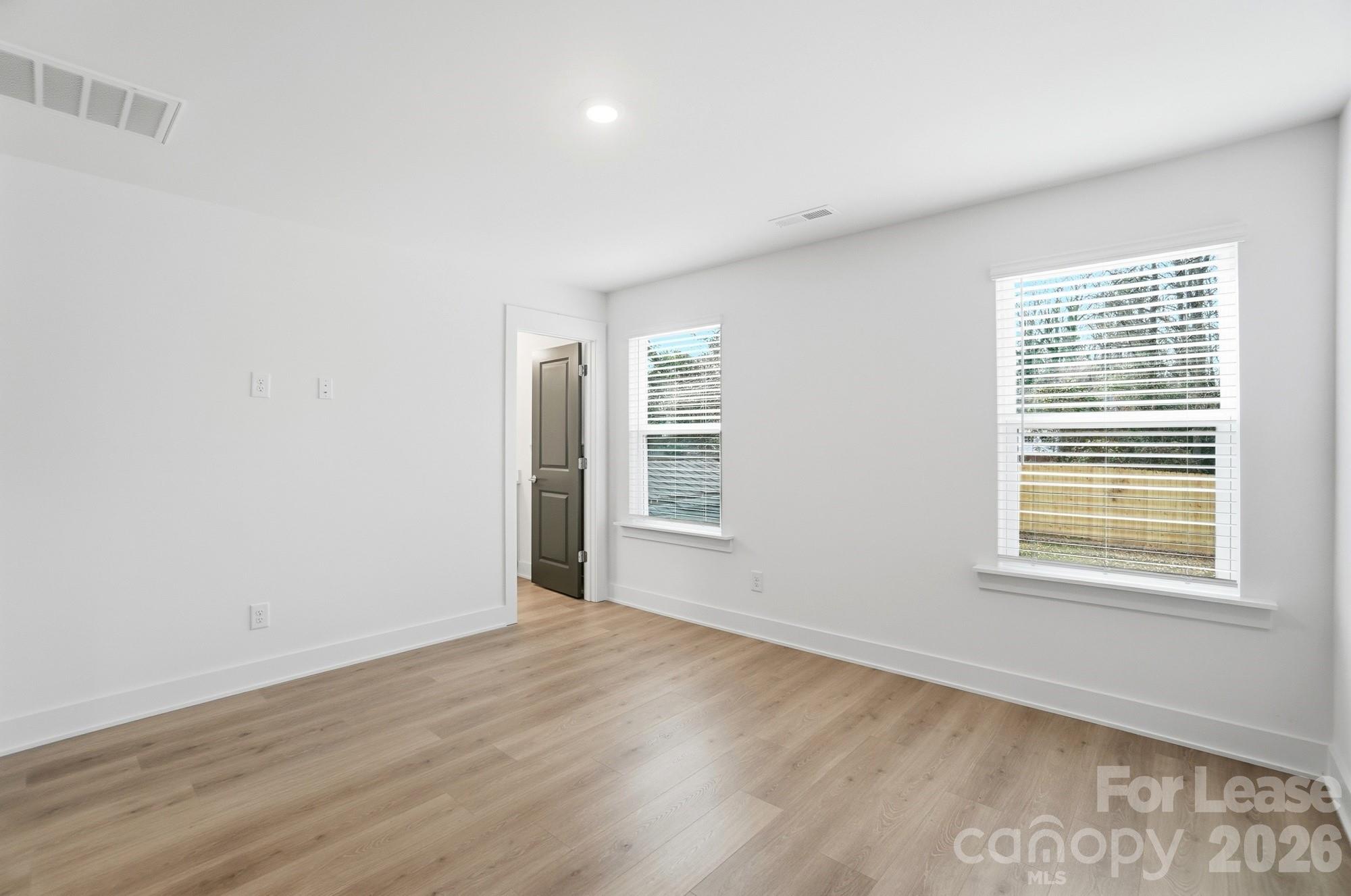3941 Tillman Road Charlotte, NC 28208 - Photo 28 of 48 an empty room with wooden floor and windows