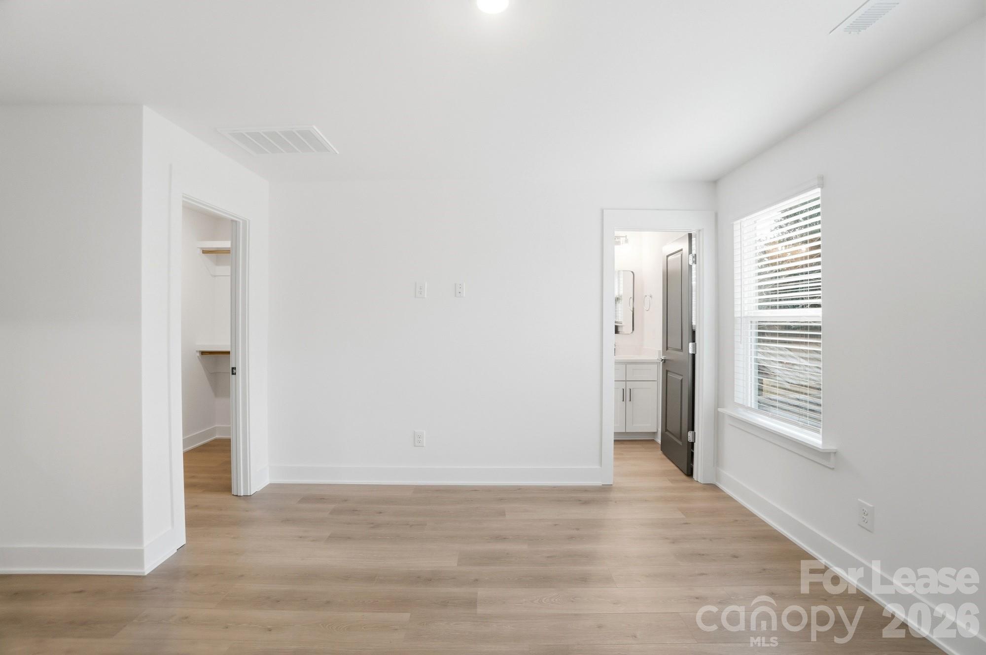 3941 Tillman Road Charlotte, NC 28208 - Photo 30 of 48 a view of an empty room with wooden floor and a window
