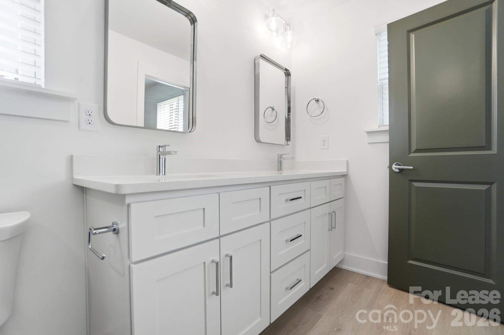 3941 Tillman Road Charlotte, NC 28208 - Photo 33 of 48 a bathroom with a double vanity sink and mirror
