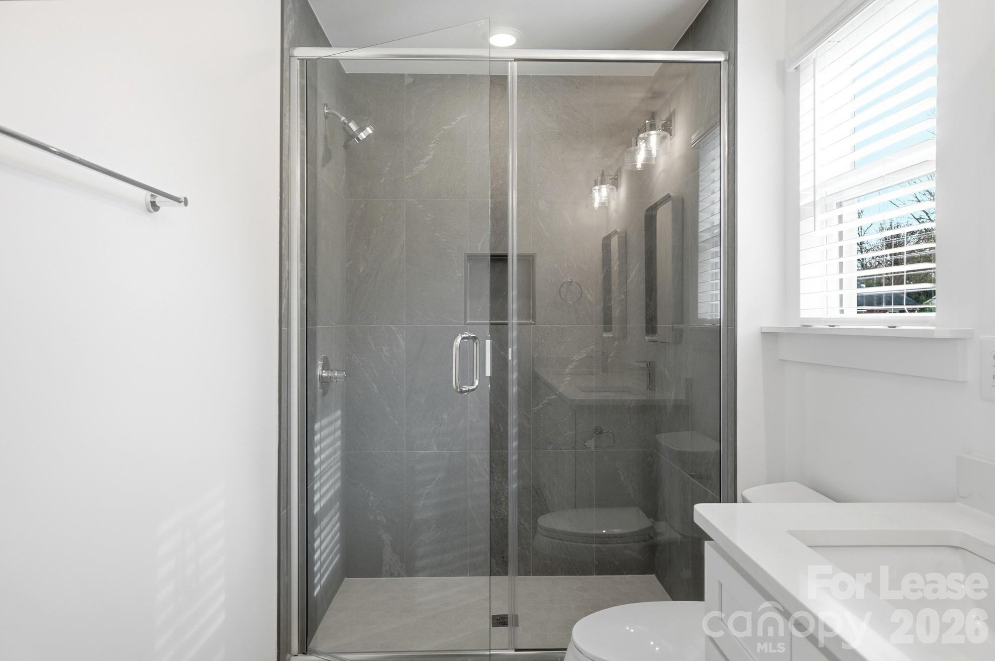 3941 Tillman Road Charlotte, NC 28208 - Photo 34 of 48 a bathroom with a shower and toilet