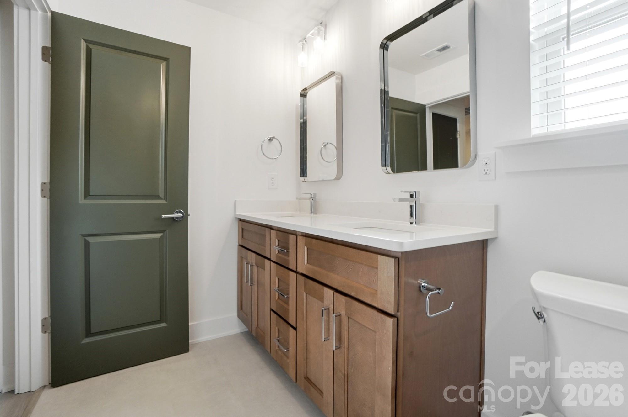 3941 Tillman Road Charlotte, NC 28208 - Photo 40 of 48 a bathroom with a sink toilet and mirror