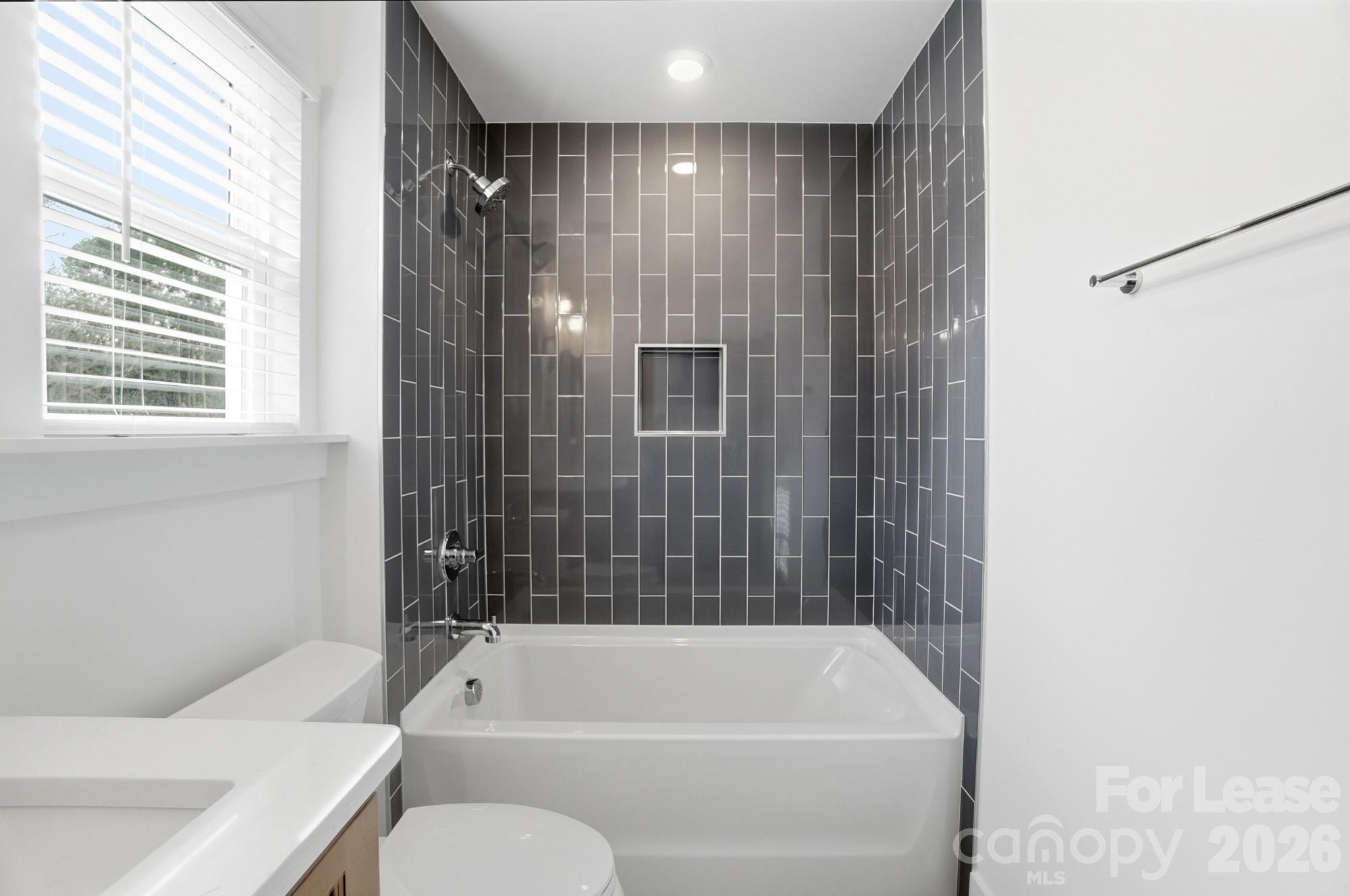 3941 Tillman Road Charlotte, NC 28208 - Photo 41 of 48 a bathroom with a toilet and bathtub