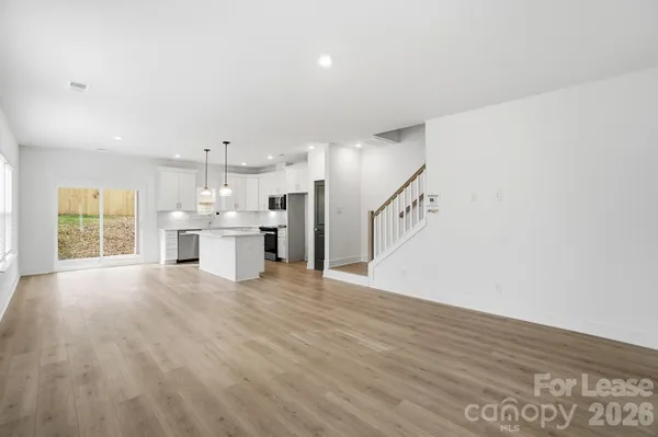 a view of a kitchen with a sink and dishwasher wooden floor